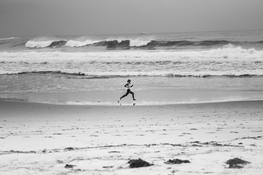 Woman running in the beach - A W Hanson IMAGES